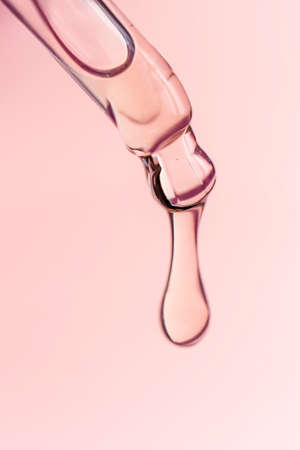 A drop of cosmetic oil falls from the pipetteの写真素材