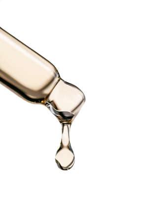 A drop of cosmetic oil falls from the pipetteの写真素材
