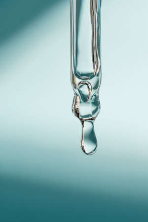 A drop of cosmetic oil falls from the pipetteの写真素材