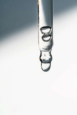 A drop of cosmetic oil falls from the pipetteの写真素材