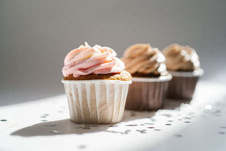 Cupcakes on a white sunny background with a shadow.の写真素材
