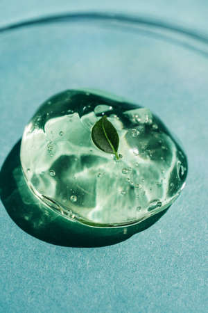Green gel texture of a cosmetic care product.の写真素材