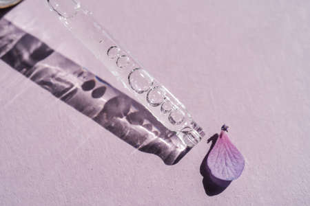 A cosmetic product flows out of a pipette with bubbles.の写真素材
