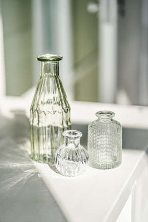 Three glass vases on the table in the interior of the house.の写真素材