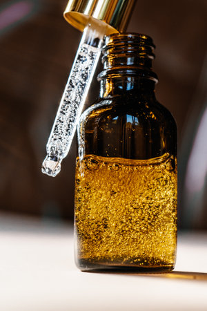 Pipette with cosmetic oil in a brown bottle with bubblesの写真素材