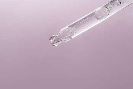 A drop of cosmetic oil falls from the pipetteの写真素材