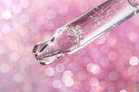 A drop of cosmetic oil falls from the pipetteの写真素材