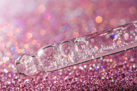 A drop of cosmetic oil falls from the pipette