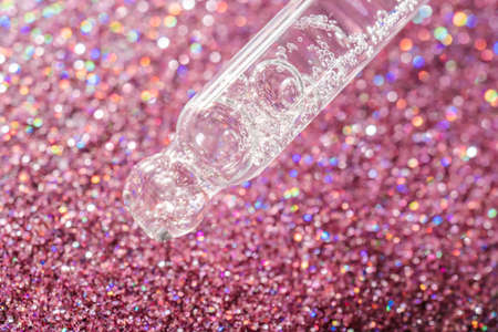 A drop of cosmetic oil falls from the pipetteの写真素材