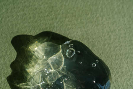 Transparent cosmetic gel on a green background.の写真素材