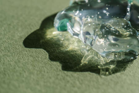 Transparent cosmetic gel on a green background.の写真素材