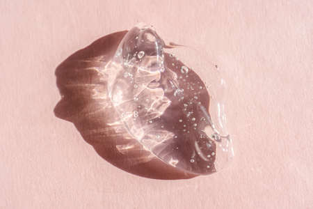 Transparent cosmetic gel on a pink background.の写真素材