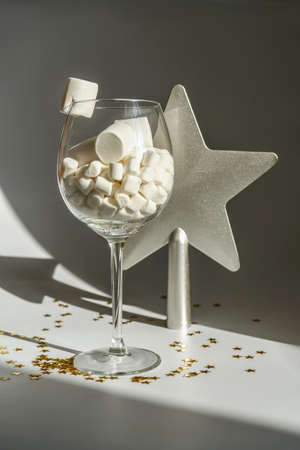 A glass with marshmallows on the background of a star.の写真素材