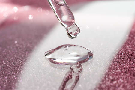 Cosmetic pipette with a pink on dark background.の写真素材