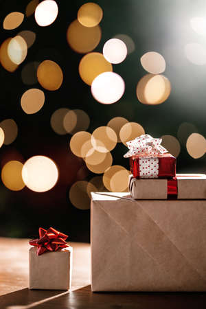 Gifts on the background of a Christmas tree with a bokeh.の写真素材