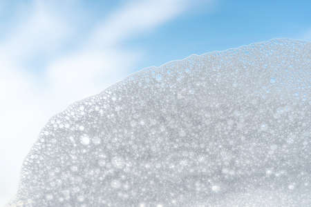 Texture of white foam on a sky background.の写真素材