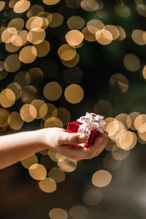 Gifts on the background of a Christmas tree with a bokeh.の写真素材
