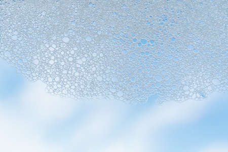 Texture of white foam on a sky background.の写真素材