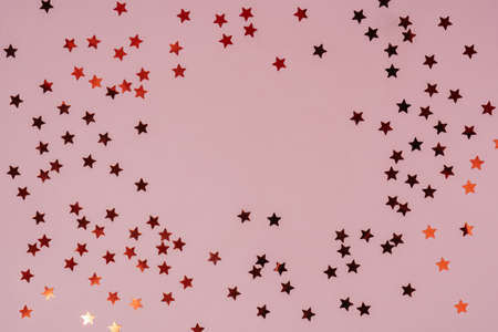 Abstract pink background with sparkles in the shape of stars.の写真素材