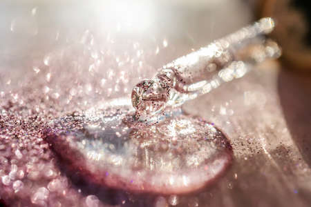 The texture of the serum or oil on an emerald background.の写真素材