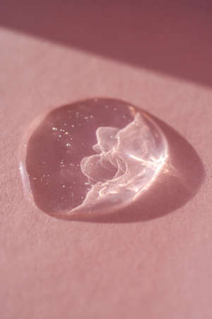 The texture of the serum or oil on an emerald background.の写真素材