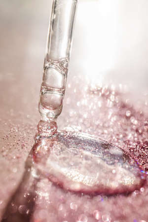 The texture of the serum or oil on an emerald background.の写真素材