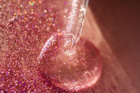 The texture of the serum or oil on an emerald background.の写真素材