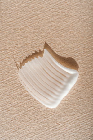 White cream texture on a beige background.の写真素材