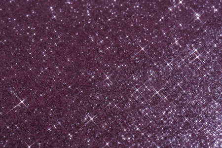 Abstract violet background with sparkles in the shape of stars.の写真素材