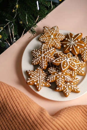 Ginger Christmas cookies on the on a delicate peach background.の写真素材