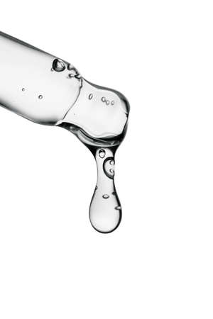 Transparent pipette with cosmetics on a white isolated background.の写真素材