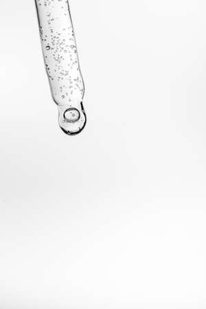 Transparent pipette with cosmetics on a white isolated background.の写真素材