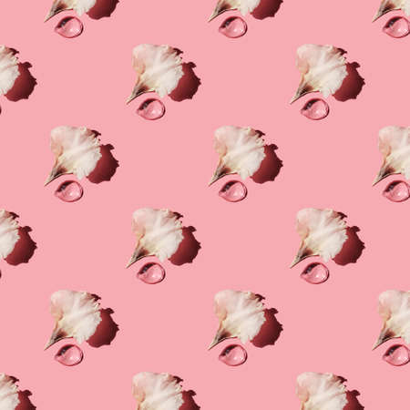 A drop of water or cosmetics from a delicate petal on a pink background. Pattern.の写真素材