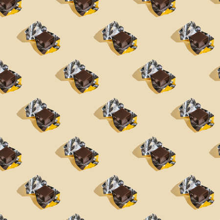 Beautiful chocolate wrapped pattern on beige background.の写真素材