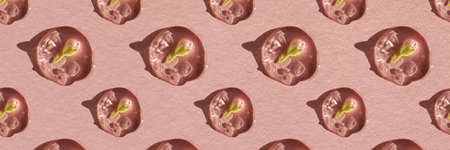 A drop of cosmetic gel with a flower on a pink background.