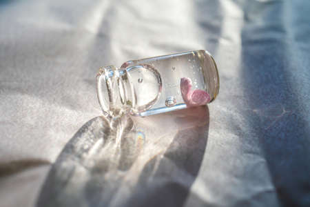 A bottle of cosmetic gel on a pink background.の写真素材
