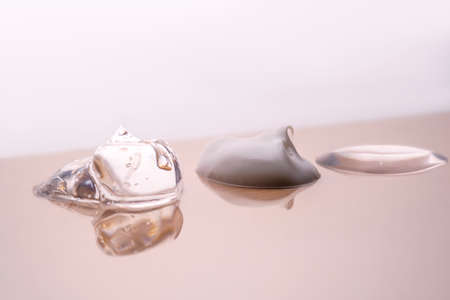 Cream, hyaluronic gel and serum on a beige background.