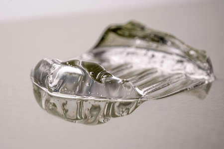 Transparent hyaluronic gel on a green background.の写真素材