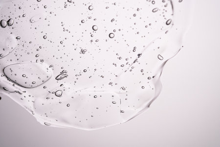 The texture of a thick cosmetic gel on a neutral background.