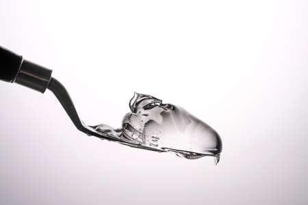 The texture of a thick cosmetic gel on a neutral background.の写真素材