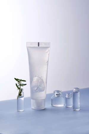 Transparent bottle of cosmetic gel on a white and blue background.