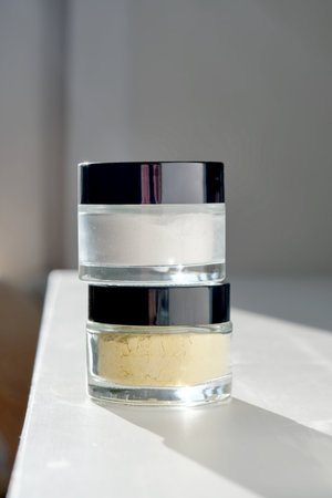 Two closed jars of face scrub.
