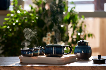 Tea set of deep blue color on a background of greenery.の写真素材