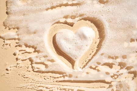 Photo of cosmetic foam or soap with a heart drawn on the foam.の写真素材