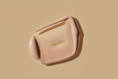 Foundation swatch with spf on a beige.