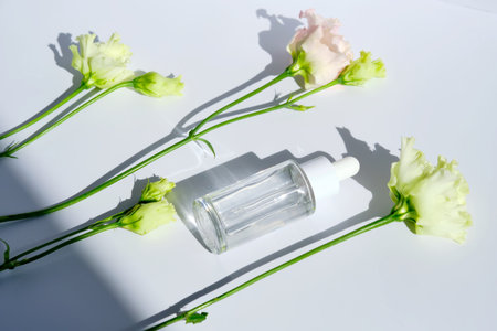 Serum with a dropper with spring flowers.の写真素材