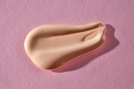 Foundation swatch with spf on a pink background.の写真素材