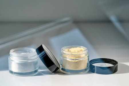 A jar of rice flour face scrub and a jar of turmeric face scrub.の写真素材