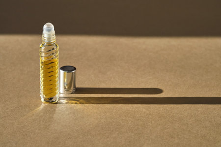 Oil roller perfume on a beige background.の写真素材