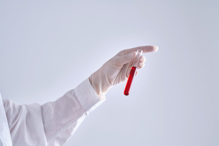 Test tube with blood in the hand.の写真素材